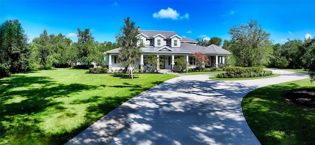 6050 Saddle Oak Trl, Sarasota, FL 34241 - view of front of house with a front lawn, a standing seam roof, and curved driveway