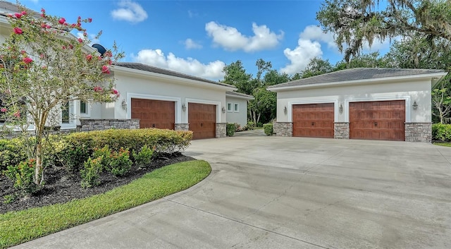 6050 Saddle Oak Trl, Sarasota, FL 34241 - view of side of home with stone siding, stucco siding, and a garage