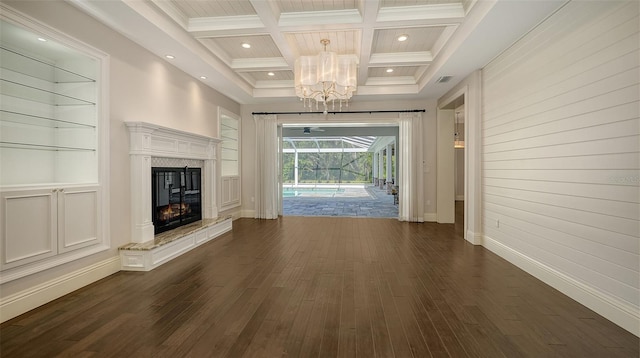 6050 Saddle Oak Trl, Sarasota, FL 34241 - unfurnished living room with coffered ceiling, a chandelier, dark wood-style floors, beamed ceiling, and built in shelves