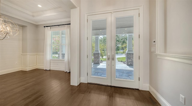 6050 Saddle Oak Trl, Sarasota, FL 34241 - doorway featuring dark wood finished floors, french doors, a chandelier, ornamental molding, and wainscoting