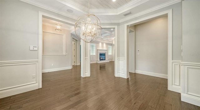 6050 Saddle Oak Trl, Sarasota, FL 34241 - spare room featuring a chandelier, wood finished floors, a decorative wall, crown molding, and a raised ceiling