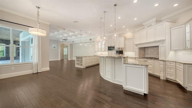 6050 Saddle Oak Trl, Sarasota, FL 34241 - kitchen with coffered ceiling, stainless steel appliances, recessed lighting, a kitchen island, and backsplash