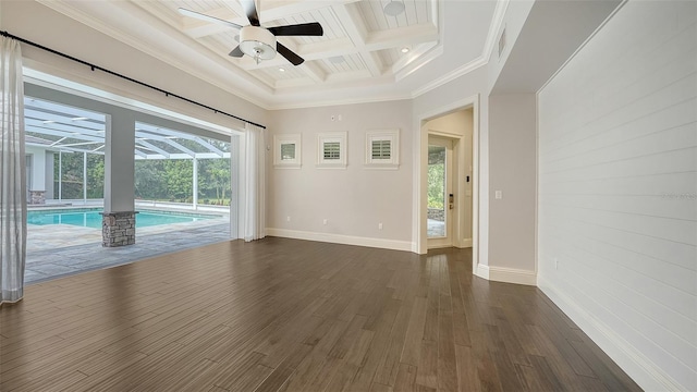 6050 Saddle Oak Trl, Sarasota, FL 34241 - empty room with coffered ceiling, plenty of natural light, beam ceiling, ceiling fan, and dark wood finished floors