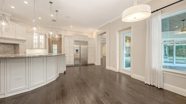6050 Saddle Oak Trl, Sarasota, FL 34241 - kitchen with stainless steel built in fridge, white cabinetry, dark wood-style flooring, decorative backsplash, and recessed lighting