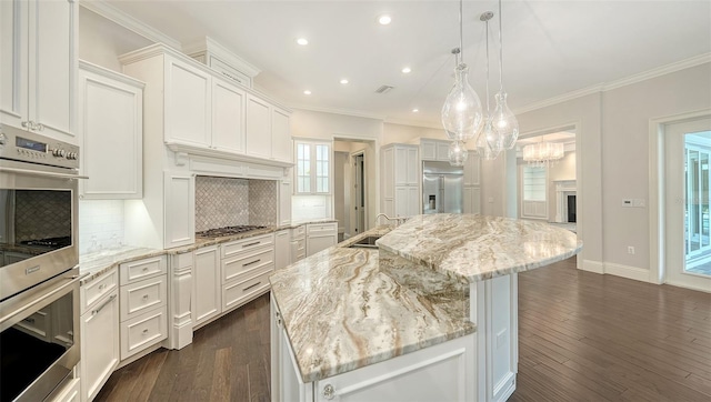 6050 Saddle Oak Trl, Sarasota, FL 34241 - kitchen featuring appliances with stainless steel finishes, a chandelier, decorative backsplash, recessed lighting, and white cabinetry