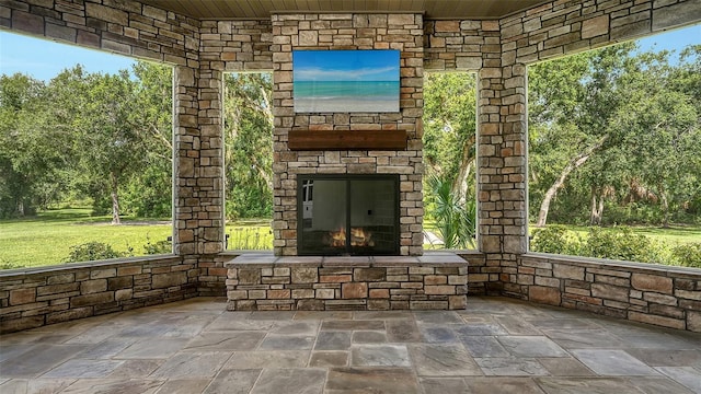 6050 Saddle Oak Trl, Sarasota, FL 34241 - view of patio featuring an outdoor stone fireplace and view of wooded area
