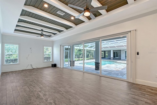 6050 Saddle Oak Trl, Sarasota, FL 34241 - spare room featuring ceiling fan, a wood ceiling with exposed beams, plenty of natural light, and wood finished floors