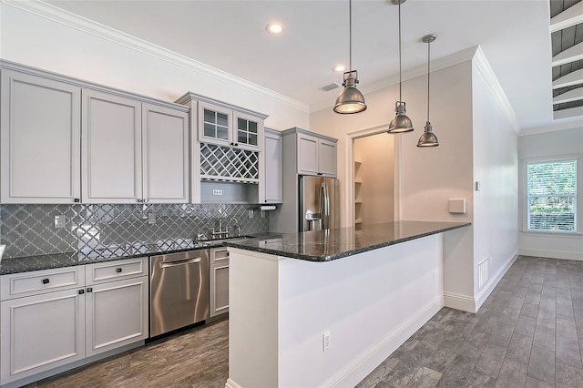 6050 Saddle Oak Trl, Sarasota, FL 34241 - kitchen featuring appliances with stainless steel finishes, gray cabinets, tasteful backsplash, ornamental molding, and dark stone countertops