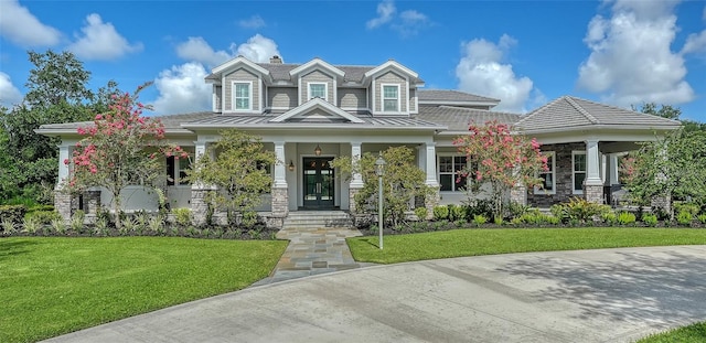 6050 Saddle Oak Trl, Sarasota, FL 34241 - view of front facade with a porch, a front lawn, a standing seam roof, and a chimney