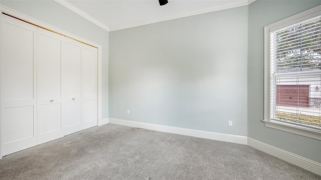 6050 Saddle Oak Trl, Sarasota, FL 34241 - unfurnished bedroom featuring carpet, a closet, and crown molding