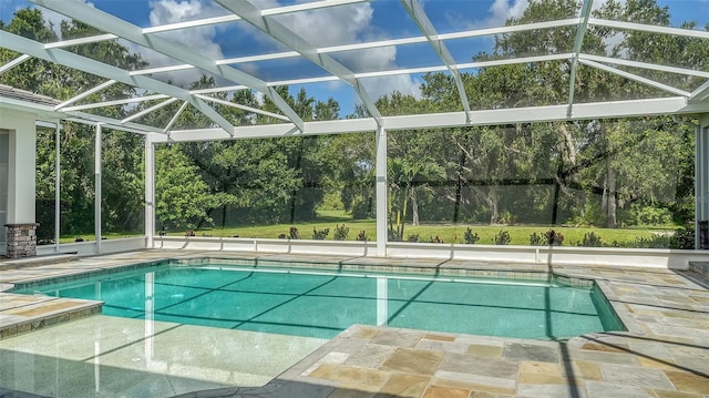 6050 Saddle Oak Trl, Sarasota, FL 34241 - swimming pool with glass enclosure, a patio, and view of scattered trees