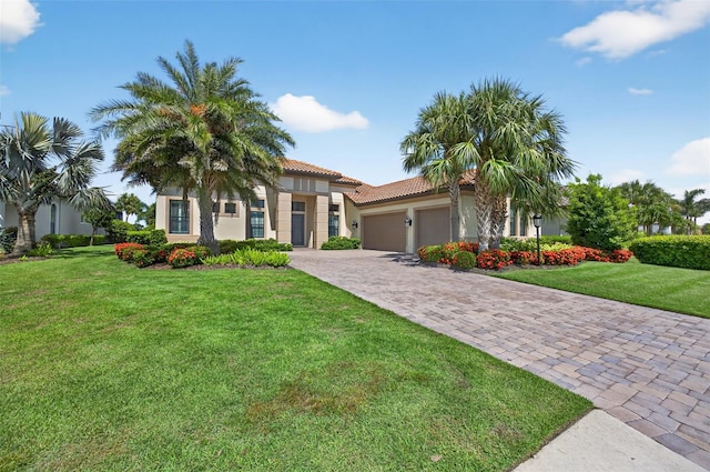 5104 Benito Ct, Bradenton, FL 34211 - mediterranean / spanish-style home featuring a garage, stucco siding, decorative driveway, a tiled roof, and a front lawn