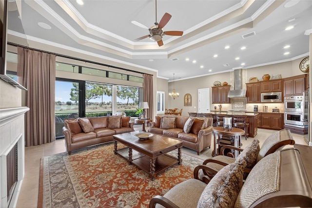 5104 Benito Ct, Bradenton, FL 34211 - living area with a tray ceiling, ornamental molding, ceiling fan, light tile patterned floors, and recessed lighting