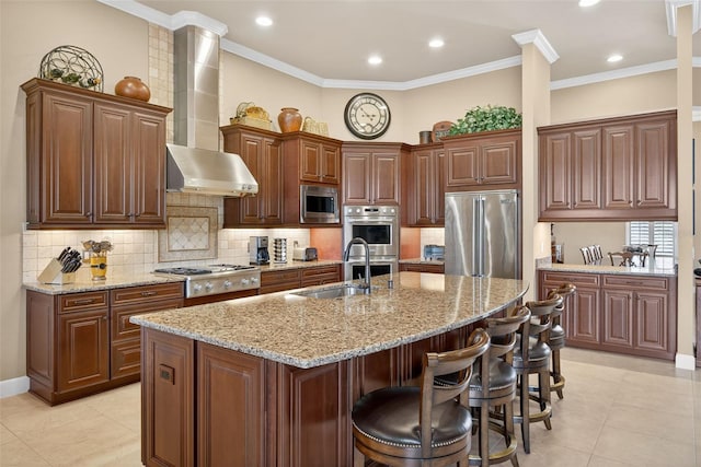 5104 Benito Ct, Bradenton, FL 34211 - kitchen with stainless steel appliances, wall chimney range hood, a kitchen bar, a kitchen island with sink, and light tile patterned floors