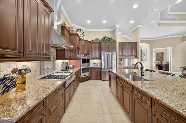 5104 Benito Ct, Bradenton, FL 34211 - kitchen with stainless steel appliances, arched walkways, tasteful backsplash, wall chimney exhaust hood, and light tile patterned floors