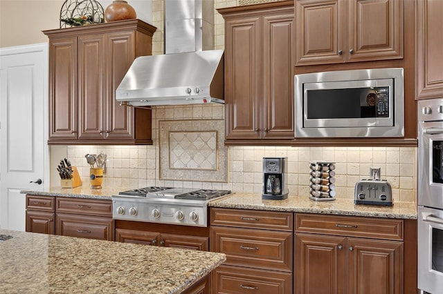 5104 Benito Ct, Bradenton, FL 34211 - kitchen featuring wall chimney exhaust hood, stainless steel appliances, light stone countertops, and decorative backsplash