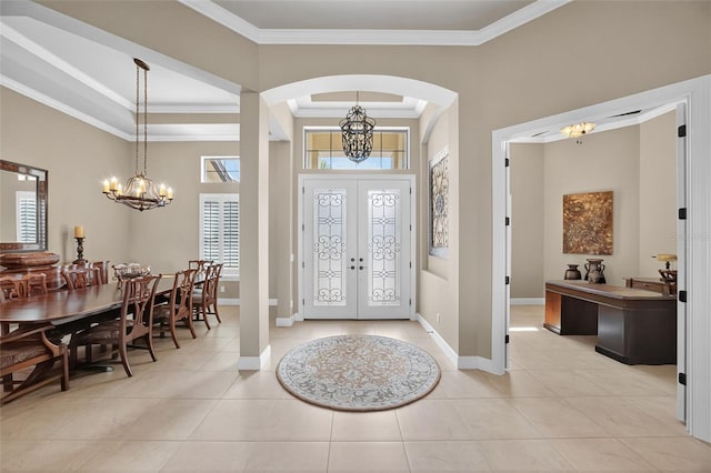 5104 Benito Ct, Bradenton, FL 34211 - entryway featuring crown molding, arched walkways, a chandelier, light tile patterned flooring, and french doors