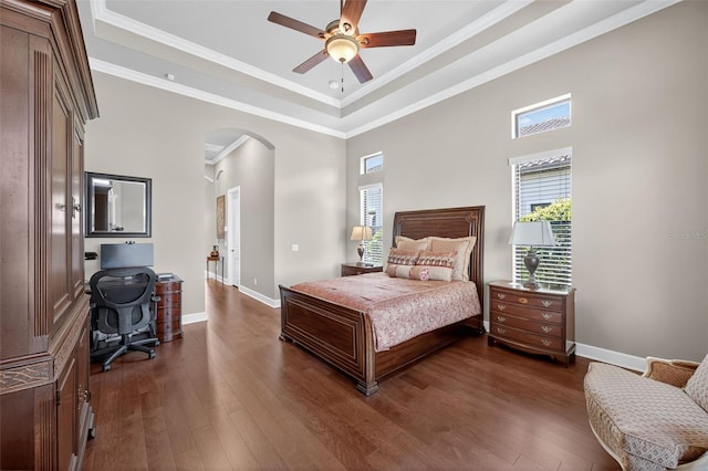 5104 Benito Ct, Bradenton, FL 34211 - bedroom featuring arched walkways, multiple windows, dark wood-type flooring, crown molding, and a tray ceiling
