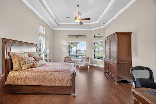 5104 Benito Ct, Bradenton, FL 34211 - bedroom with a tray ceiling, multiple windows, dark wood-type flooring, crown molding, and a desk