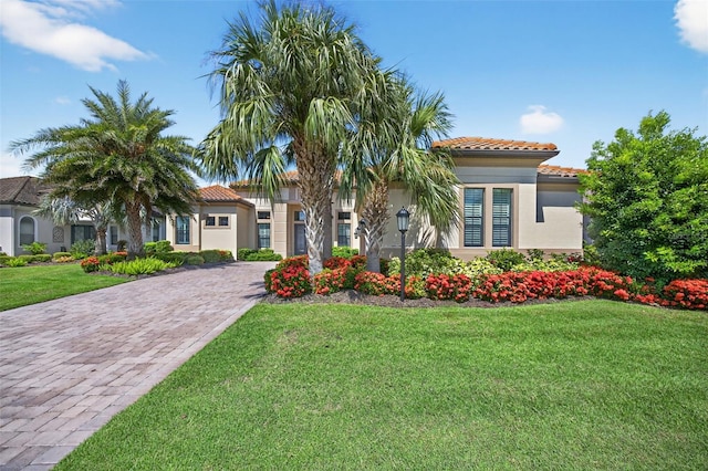5104 Benito Ct, Bradenton, FL 34211 - mediterranean / spanish-style home with a tiled roof, decorative driveway, stucco siding, and a front yard