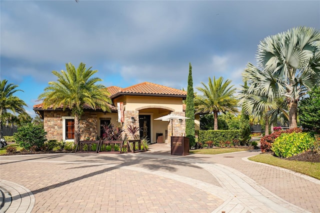 5104 Benito Ct, Bradenton, FL 34211 - view of front facade featuring stone siding, a tile roof, and stucco siding