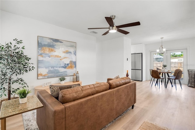 2802 21st St W, Bradenton, FL 34205 - living area featuring a ceiling fan, light wood-style floors, and a chandelier