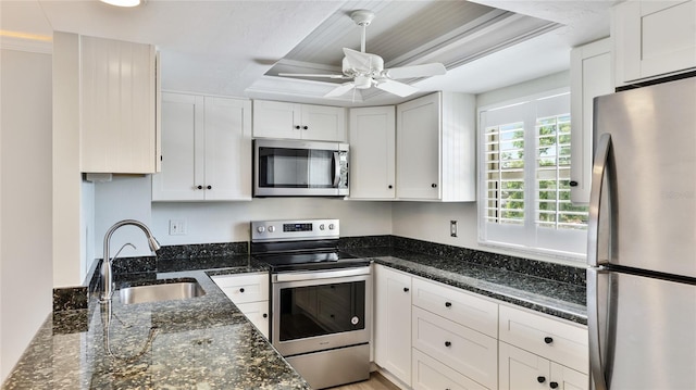 1257 S Portofino Dr Unit 306, Sarasota, FL 34242 - kitchen with stainless steel appliances, white cabinets, a raised ceiling, ceiling fan, and dark stone counters