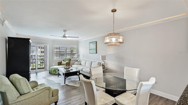 1257 S Portofino Dr Unit 306, Sarasota, FL 34242 - living room featuring crown molding, wood finished floors, a chandelier, and ceiling fan