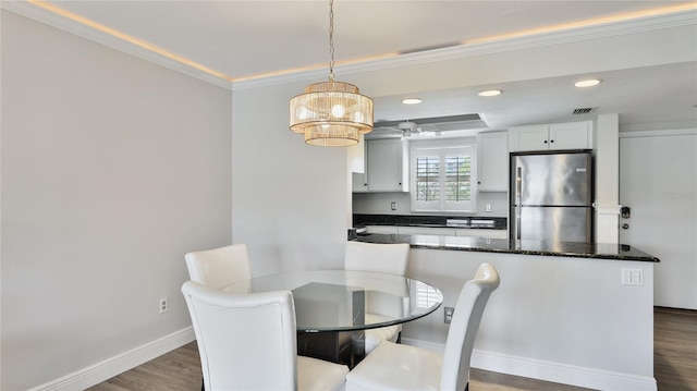 1257 S Portofino Dr Unit 306, Sarasota, FL 34242 - dining space with ornamental molding, dark wood-style floors, recessed lighting, and a chandelier