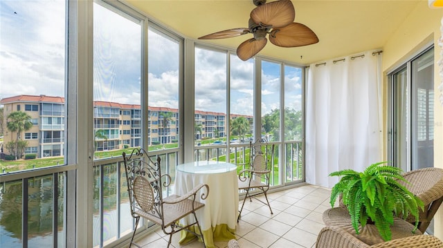 1257 S Portofino Dr Unit 306, Sarasota, FL 34242 - sunroom / solarium with tile patterned flooring, expansive windows, and a ceiling fan