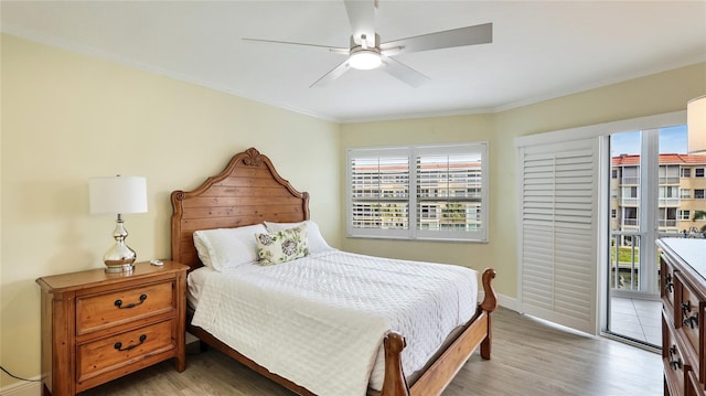 1257 S Portofino Dr Unit 306, Sarasota, FL 34242 - bedroom featuring multiple windows, crown molding, access to exterior, light wood finished floors, and ceiling fan