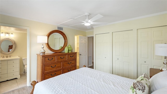 1257 S Portofino Dr Unit 306, Sarasota, FL 34242 - bedroom with multiple closets, crown molding, ensuite bathroom, and a ceiling fan