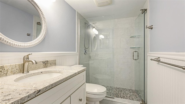 1257 S Portofino Dr Unit 306, Sarasota, FL 34242 - full bathroom featuring a wainscoted wall, a shower stall, and vanity