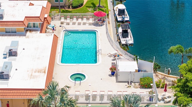 1257 S Portofino Dr Unit 306, Sarasota, FL 34242 - drone / aerial view of a pool and a nearby body of water