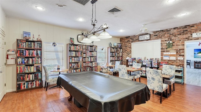 1257 S Portofino Dr Unit 306, Sarasota, FL 34242 - playroom with wood finished floors, ceiling fan, recessed lighting, brick wall, and billiards
