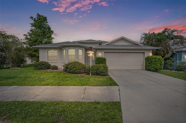 1042 Whitegate Ct, Sarasota, FL 34232 - ranch-style home with driveway, a garage, stucco siding, and a front lawn
