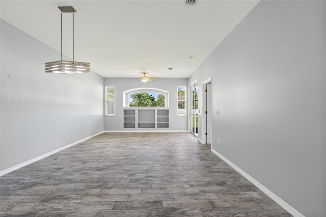 1042 Whitegate Ct, Sarasota, FL 34232 - unfurnished living room with wood finished floors and a ceiling fan