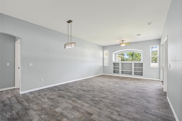 1042 Whitegate Ct, Sarasota, FL 34232 - unfurnished room featuring dark wood finished floors, a ceiling fan, and arched walkways