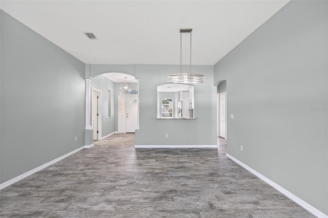 1042 Whitegate Ct, Sarasota, FL 34232 - unfurnished room with arched walkways and wood finished floors