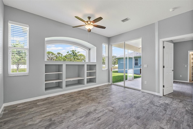 1042 Whitegate Ct, Sarasota, FL 34232 - empty room featuring wood finished floors, a ceiling fan, built in features, and a smoke detector