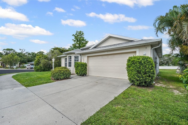 1042 Whitegate Ct, Sarasota, FL 34232 - view of front facade featuring an attached garage, concrete driveway, a front yard, and stucco siding
