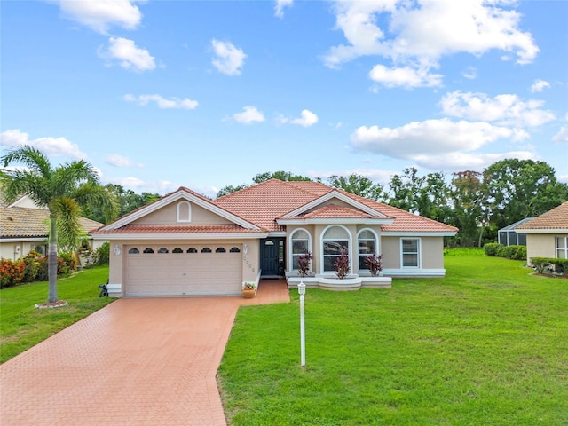 7115 39th Ln E, Sarasota, FL 34243 - mediterranean / spanish house with driveway, stucco siding, a garage, and a front yard