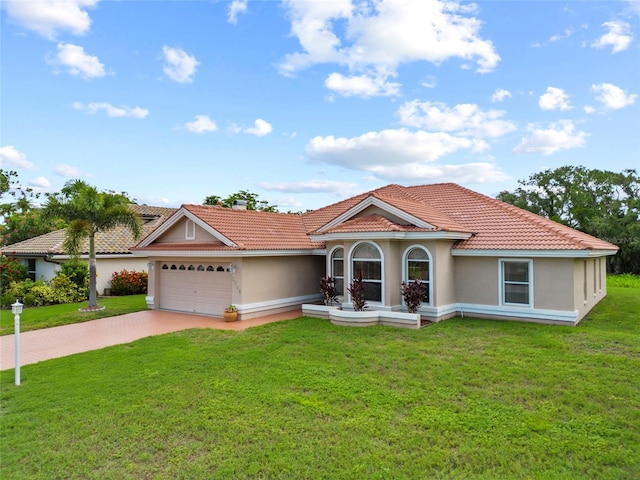 7115 39th Ln E, Sarasota, FL 34243 - view of front of house featuring a tiled roof, driveway, a front yard, and stucco siding