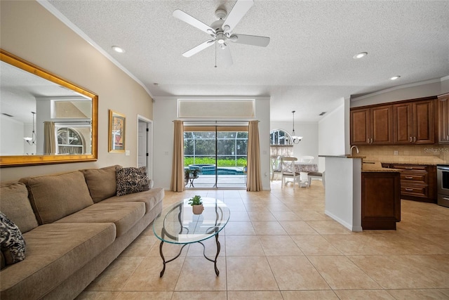 7115 39th Ln E, Sarasota, FL 34243 - living area featuring light tile patterned floors, a textured ceiling, a ceiling fan, crown molding, and a chandelier