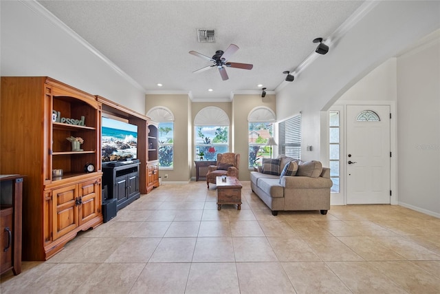 7115 39th Ln E, Sarasota, FL 34243 - living area with light tile patterned floors, ornamental molding, a ceiling fan, a textured ceiling, and arched walkways