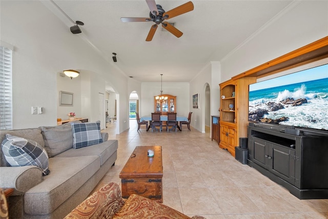 7115 39th Ln E, Sarasota, FL 34243 - living area with arched walkways, light tile patterned flooring, a ceiling fan, a chandelier, and crown molding