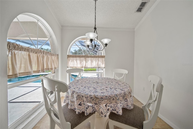 7115 39th Ln E, Sarasota, FL 34243 - dining area with a chandelier, crown molding, and a textured ceiling