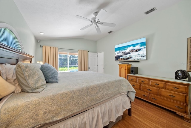 7115 39th Ln E, Sarasota, FL 34243 - bedroom featuring access to outside, wood finished floors, lofted ceiling, and a ceiling fan