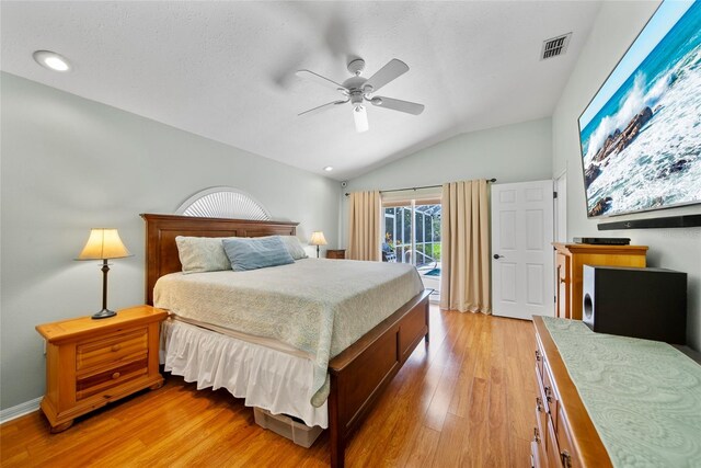 7115 39th Ln E, Sarasota, FL 34243 - bedroom with access to outside, lofted ceiling, light wood finished floors, a ceiling fan, and recessed lighting