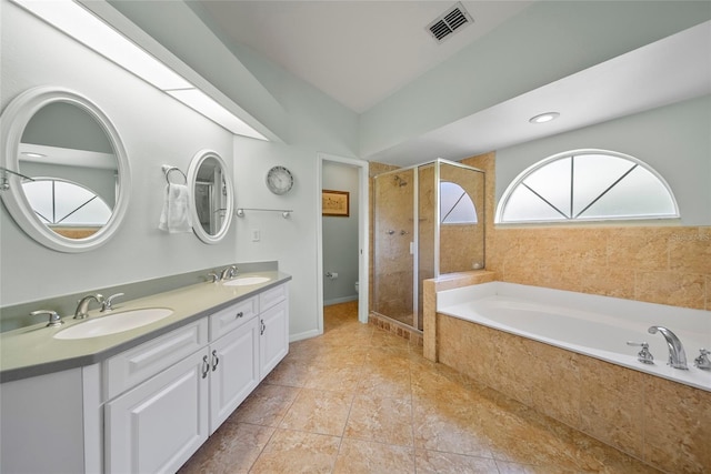7115 39th Ln E, Sarasota, FL 34243 - full bathroom with a bath, double vanity, and a stall shower